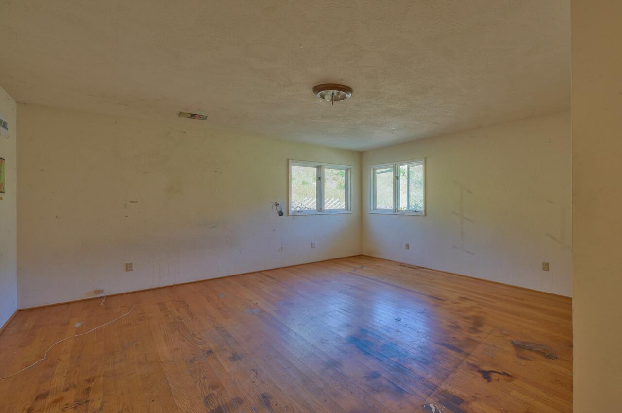 26045 Toro Road Salinas, CA 93908 - Photo 20 of 35 an empty room with wooden floor and windows