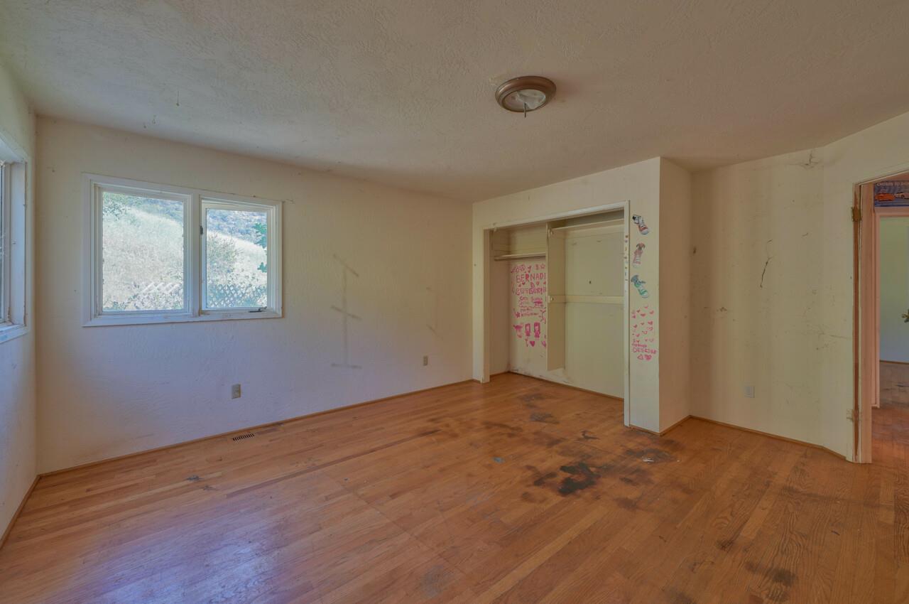 26045 Toro Road Salinas, CA 93908 - Photo 21 of 35 a view of an empty room with wooden floor and a window