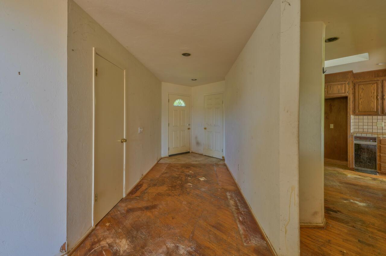 26045 Toro Road Salinas, CA 93908 - Photo 25 of 35 a view of a hallway with wooden floor and a bathroom