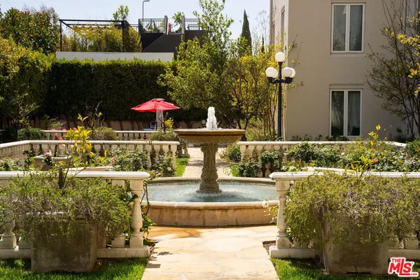a front view of a house with fountain
