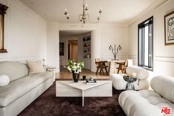 a living room with furniture potted plant and a window