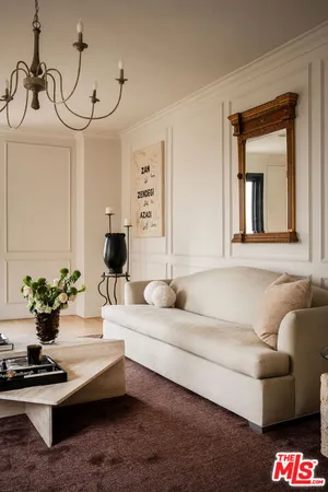 a living room with furniture and flowers