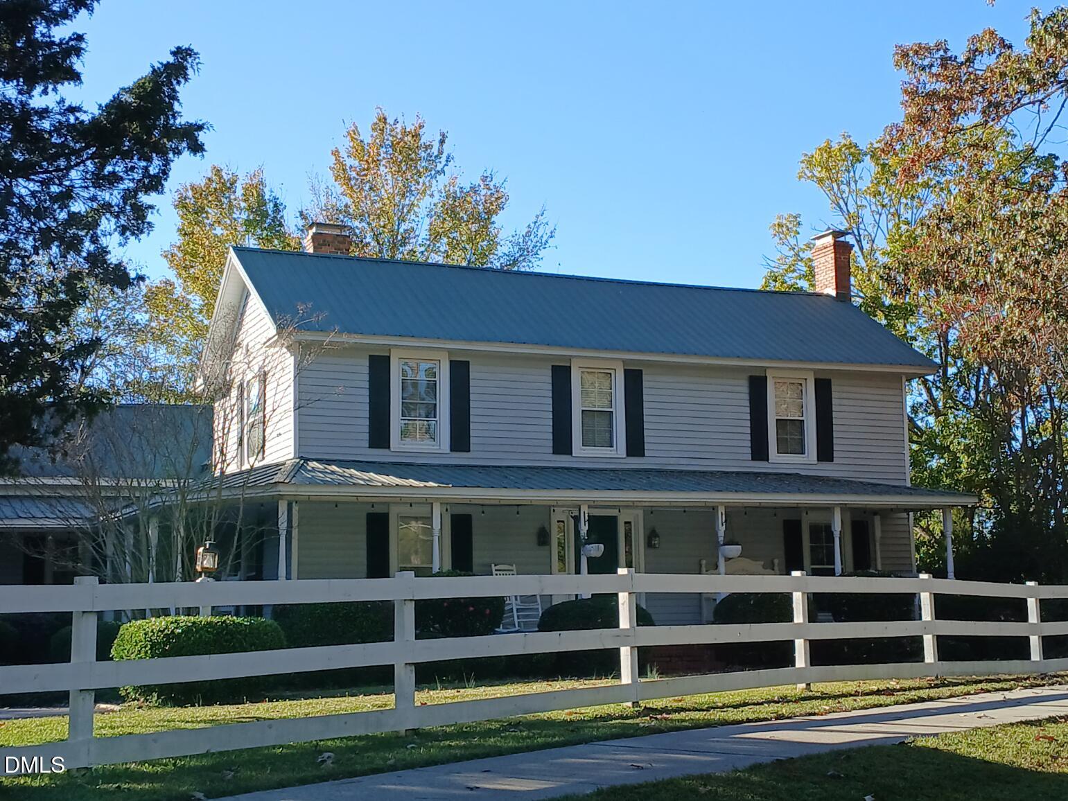 a front view of a house with a yard table and chairs