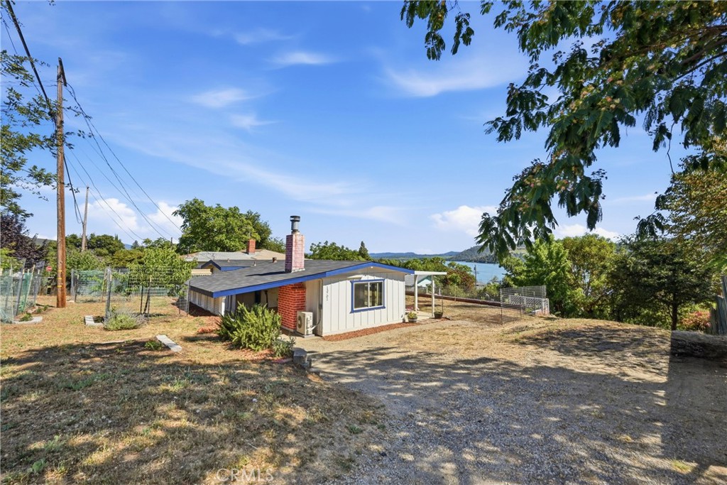 13701 Arrowhead Road Clearlake, CA 95422 - Photo 15 of 21 View of the house and front yard with fruit trees.