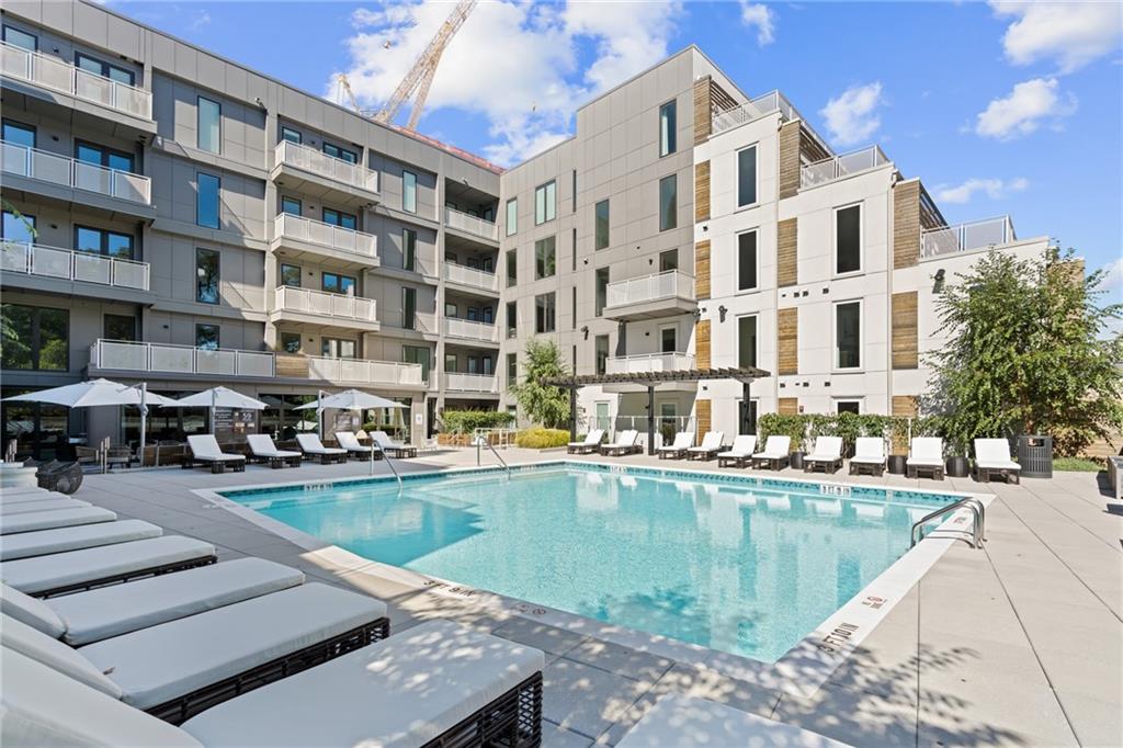 775 Juniper Street Northeast, Unit 227 Atlanta, GA 30308 - Photo 19 of 42 a view of a swimming pool with outdoor seating