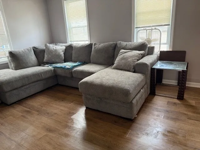 a workspace with furniture wooden floor and window