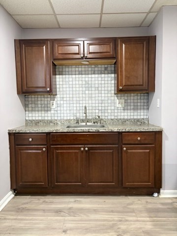 207 Rodman Street Fall River, MA 02721 - Photo 11 of 36 a kitchen with stainless steel appliances granite countertop wooden cabinets and a sink