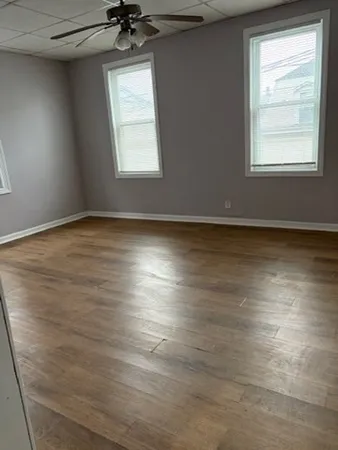 a workspace with furniture wooden floor and window