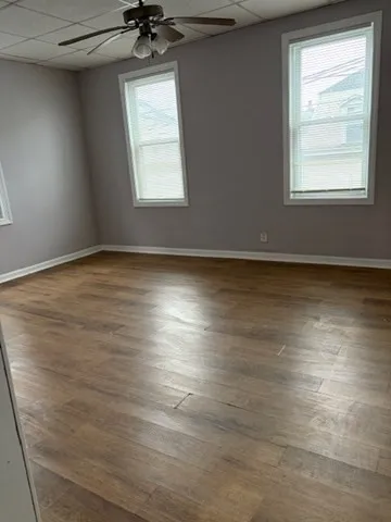 a workspace with furniture wooden floor and window
