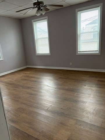 207 Rodman Street Fall River, MA 02721 - Photo 13 of 36 an empty room with wooden floor and windows