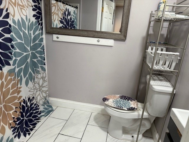 207 Rodman Street Fall River, MA 02721 - Photo 14 of 36 a bathroom with a toilet and a shower curtain