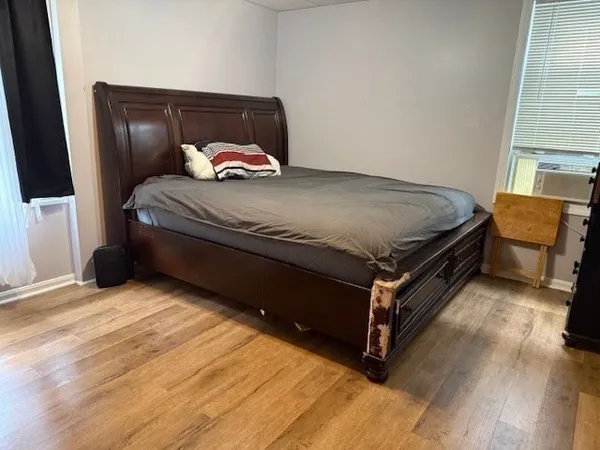 a bedroom with a bed and window