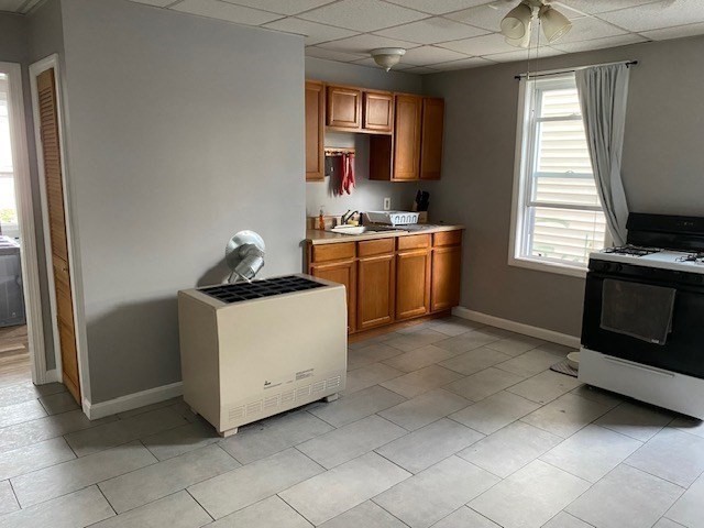 207 Rodman Street Fall River, MA 02721 - Photo 18 of 36 a kitchen with granite countertop a stove a sink and a refrigerator