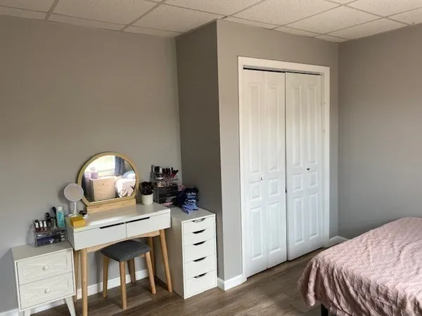 an empty room with windows and wooden door