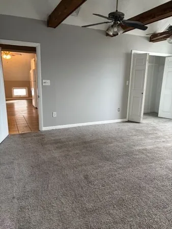 a kitchen with granite countertop white cabinets and a stove