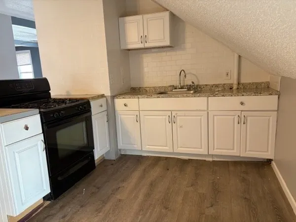 a view of a kitchen with wooden floor