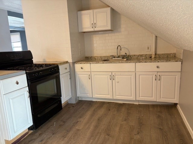 207 Rodman Street Fall River, MA 02721 - Photo 31 of 36 a kitchen with granite countertop white cabinets and a stove