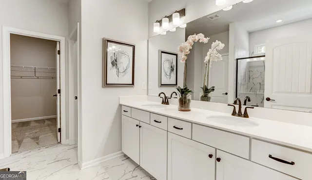 a bathroom with a double vanity sink mirror and shower