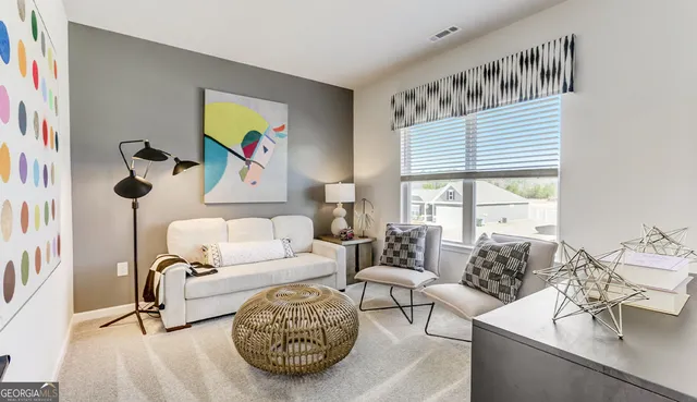 a living room with furniture and a large window