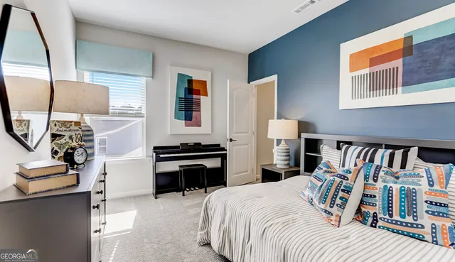 a bedroom with furniture and a wooden floor