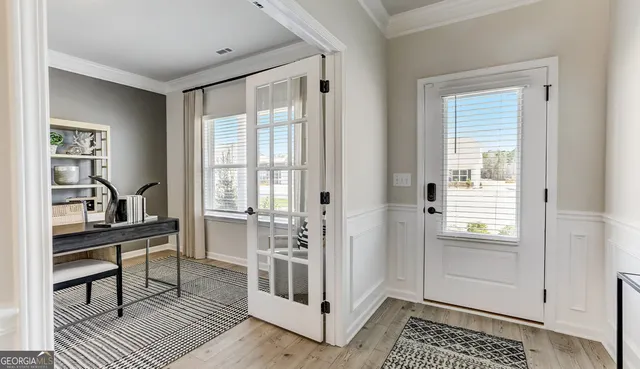 a view of a livingroom with wooden floor and furniture