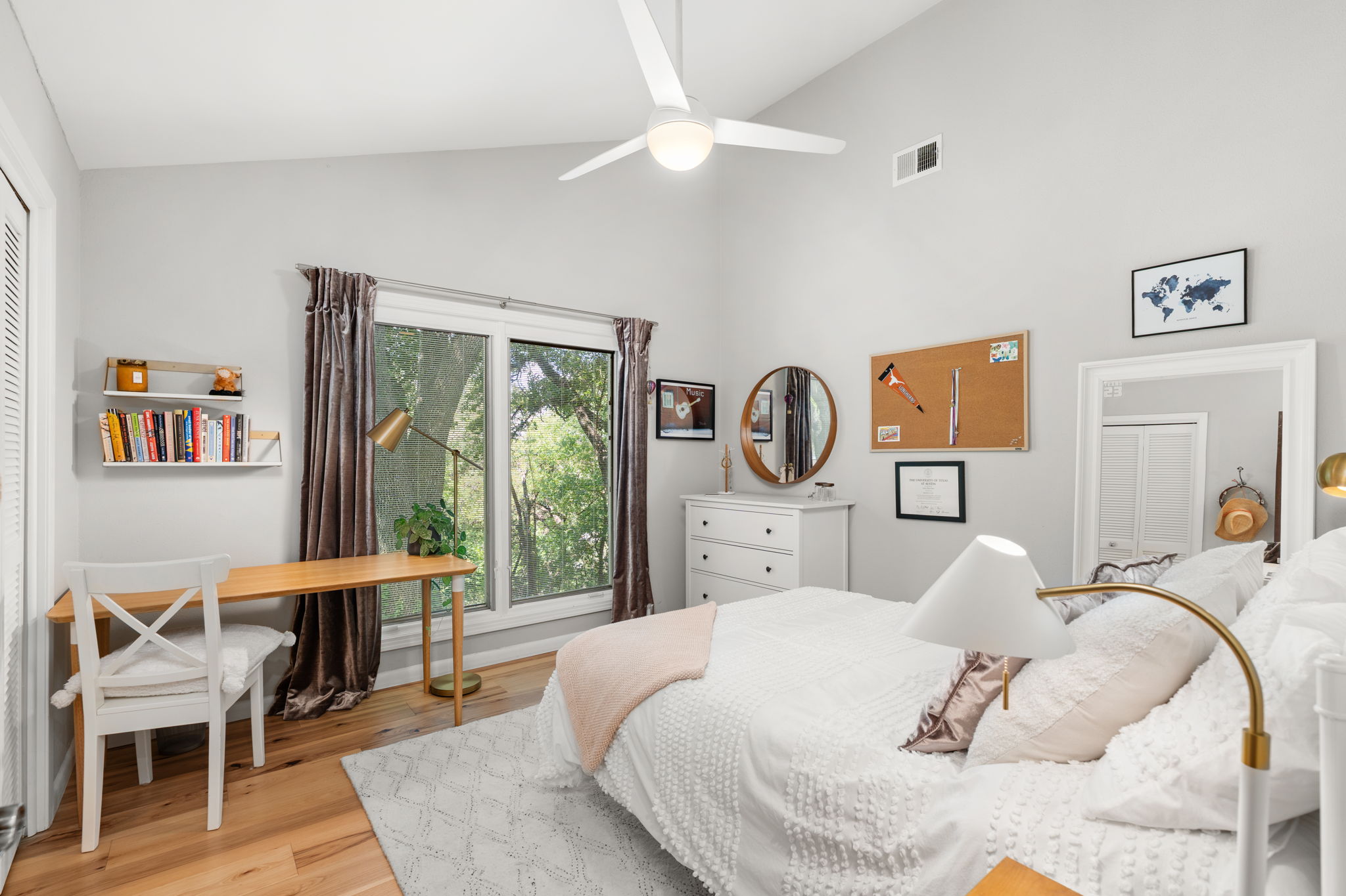 2310 Camino Alto Road Austin, TX 78746 - Photo 24 of 29 a bedroom with a bed a table and a large window
