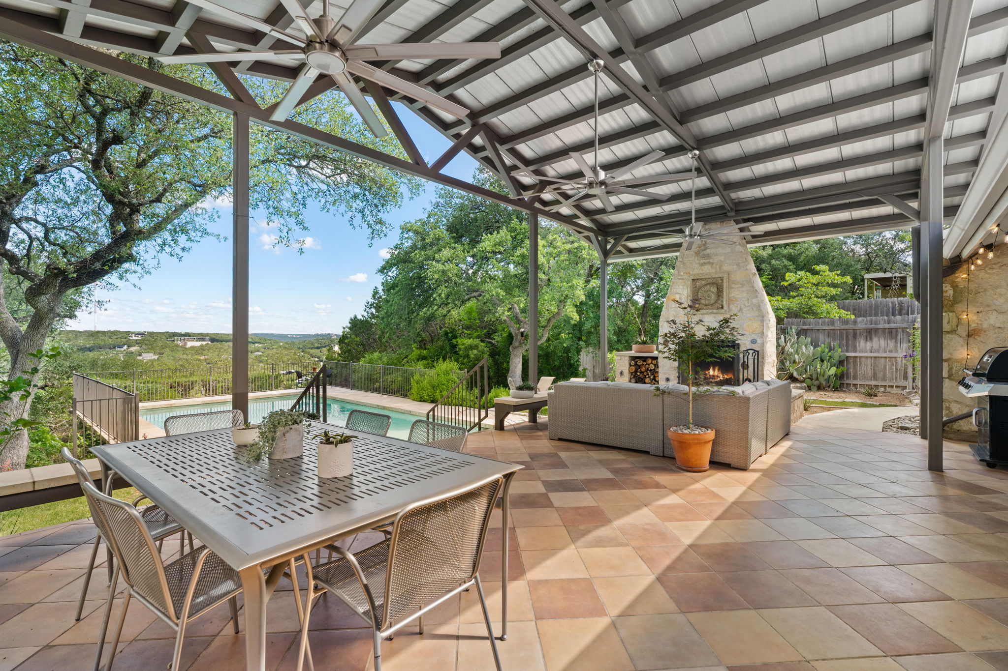2310 Camino Alto Road Austin, TX 78746 - Photo 26 of 29 a view of an outdoor dining space with a table and chairs