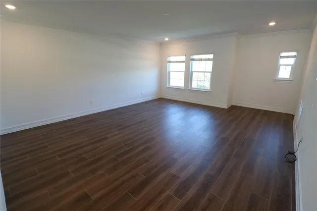 a kitchen with cabinets and wooden floor