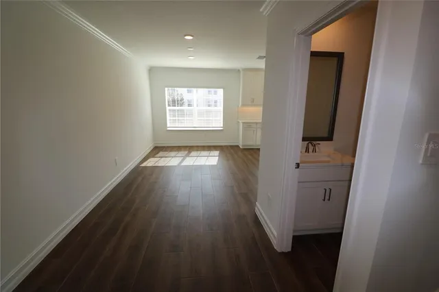 a large kitchen with stainless steel appliances kitchen island a large counter top and a wooden floors