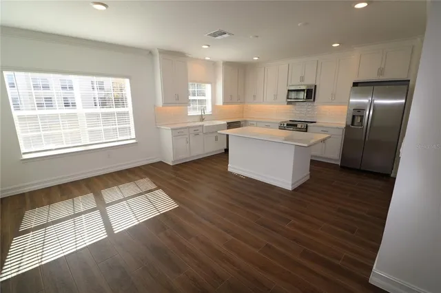 a kitchen with stainless steel appliances wooden cabinets and a sink