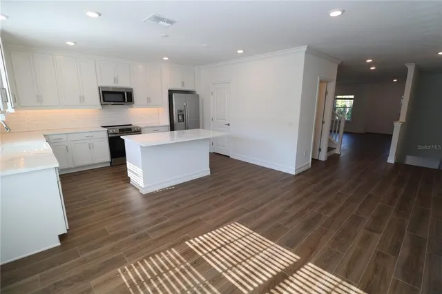 a view of a room with wooden floor