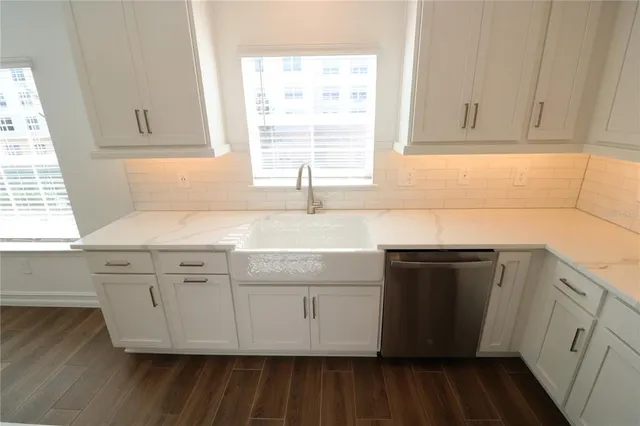 a spacious bathroom with a granite countertop sink and a large mirror