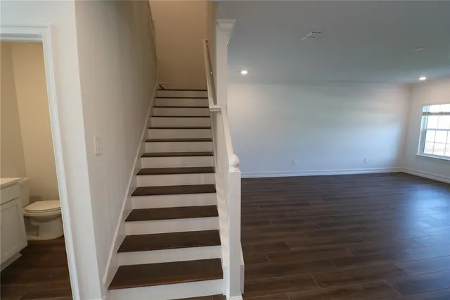 a bathroom with a toilet and a bath tub