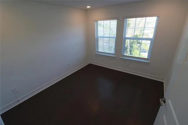 a spacious bathroom with a double vanity sink and mirror