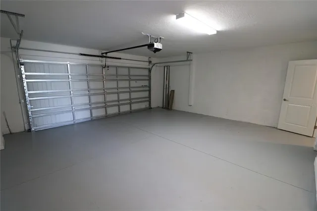 a view of an empty room with wooden floor and closet