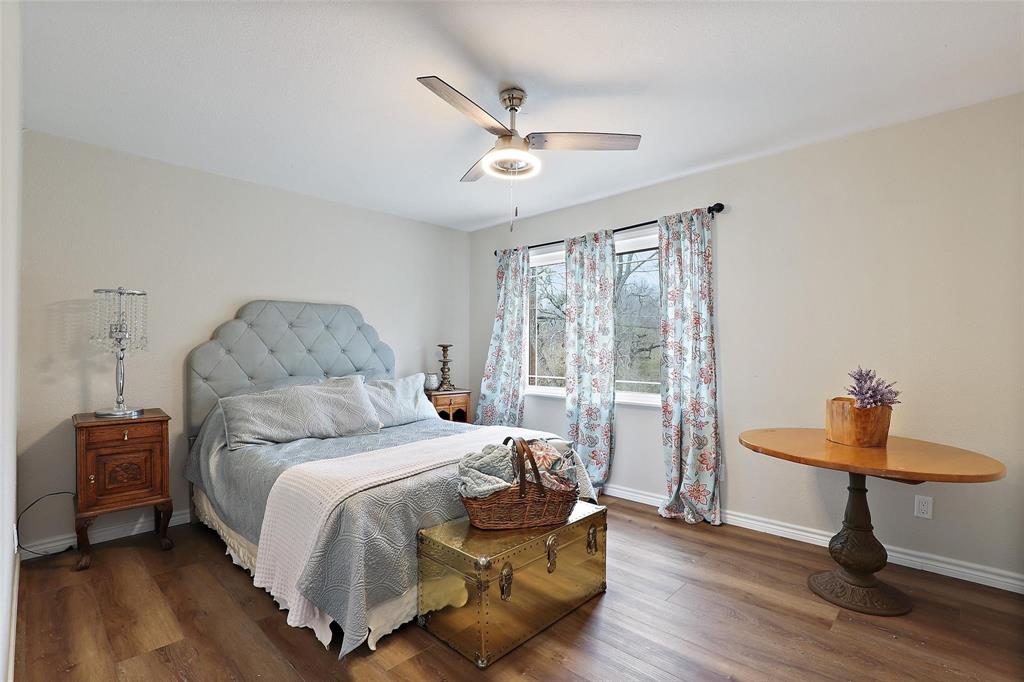 110 Vanshire Road West Lakeside, TX 76108 - Photo 24 of 34 a bedroom with a bed and a chandelier