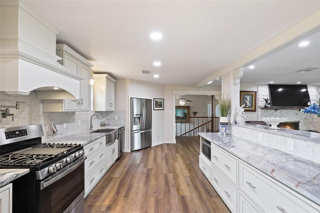 110 Vanshire Road West Lakeside, TX 76108 - Photo 8 of 34 a large kitchen with stainless steel appliances granite countertop a lot of counter space and wooden floor