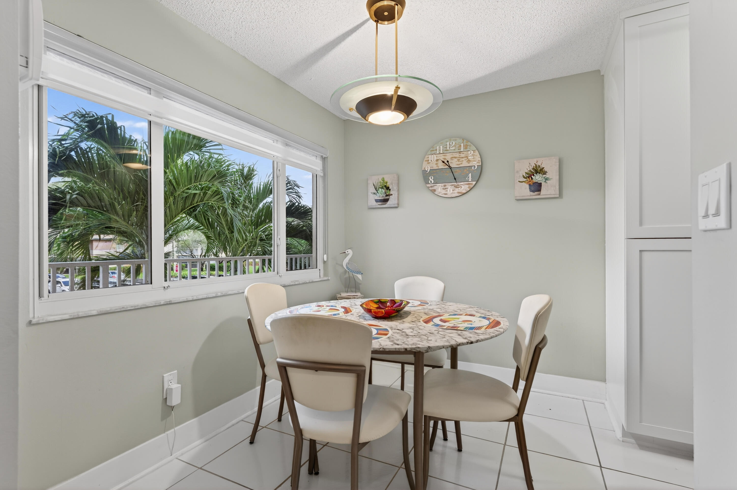 7142 South Devon Drive, Unit 210 Tamarac, FL 33321 - Photo 20 of 36 a dining room with furniture a rug and a large window