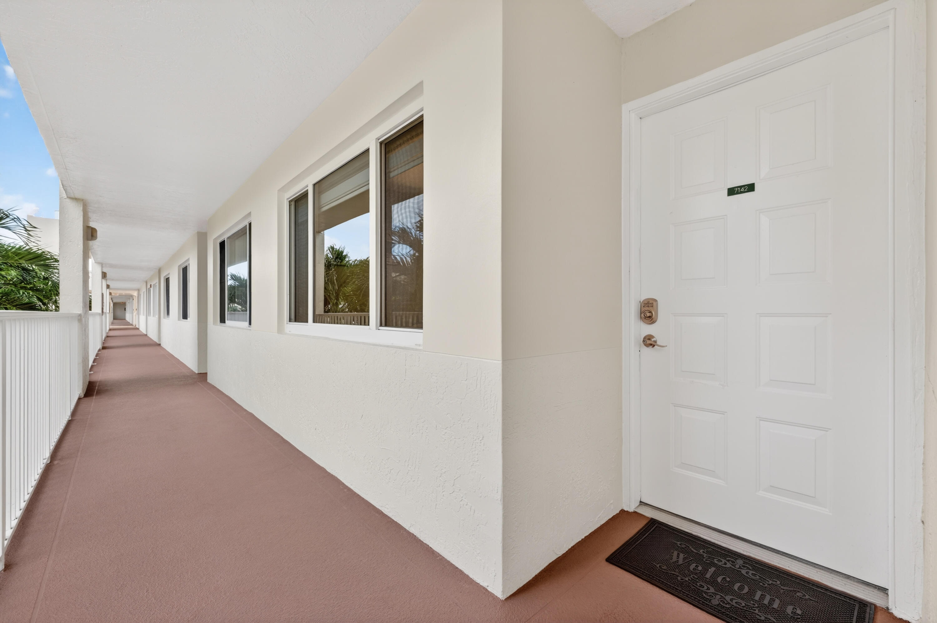 7142 South Devon Drive, Unit 210 Tamarac, FL 33321 - Photo 2 of 36 a view of an entryway with wooden floor and door