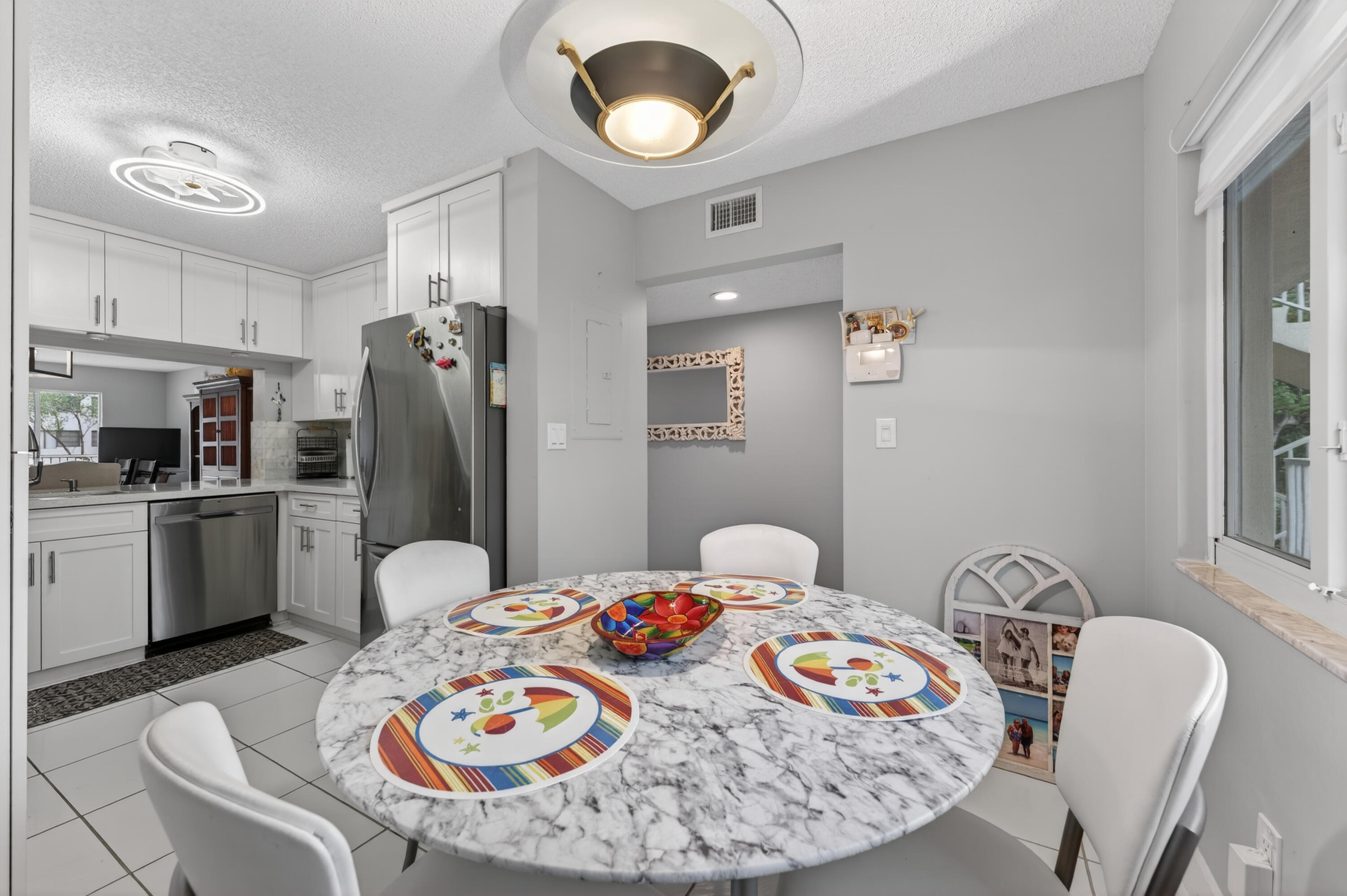 7142 South Devon Drive, Unit 210 Tamarac, FL 33321 - Photo 21 of 36 a dining room with furniture and window