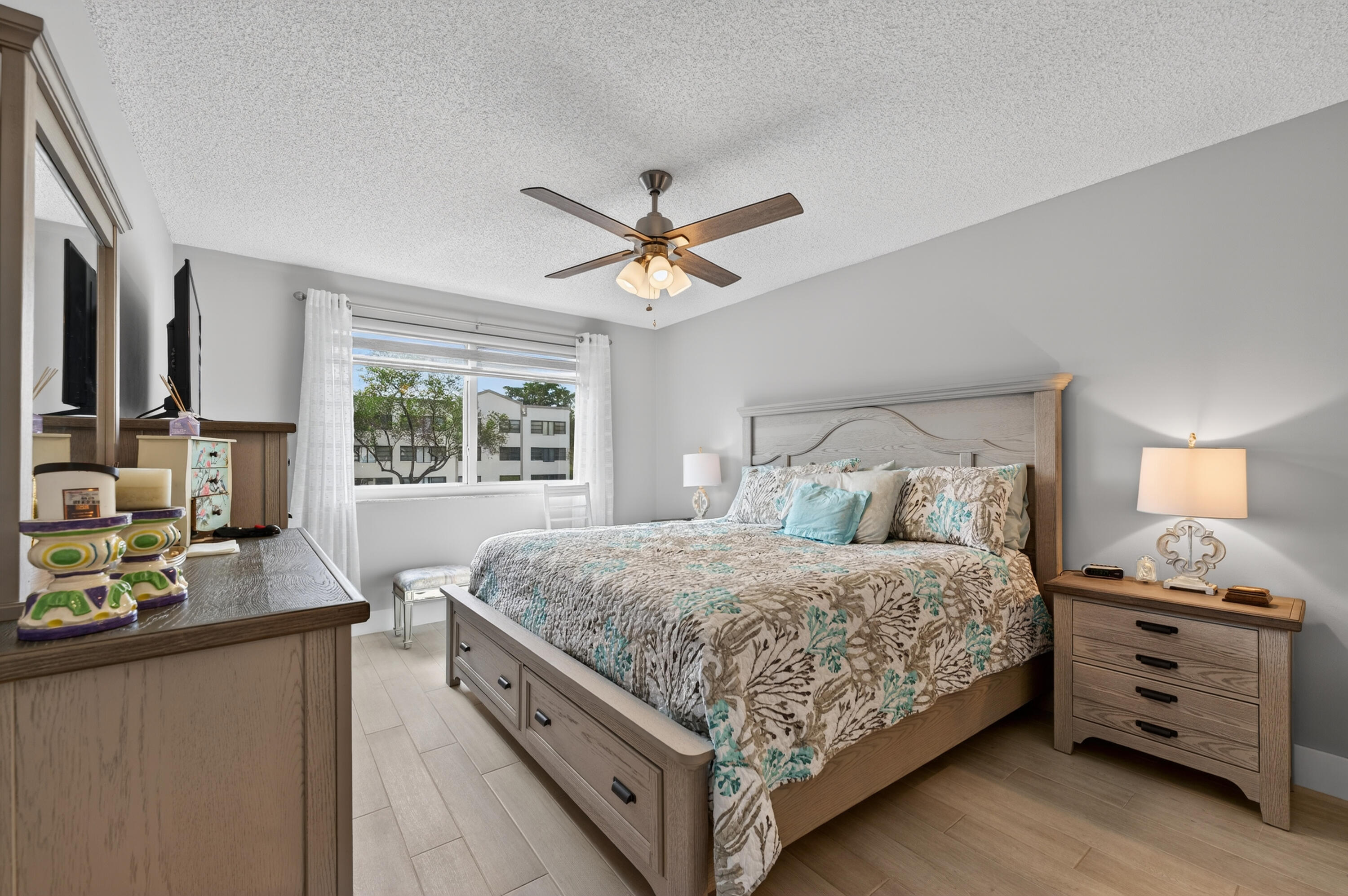 7142 South Devon Drive, Unit 210 Tamarac, FL 33321 - Photo 22 of 36 a bedroom with a bed and a window