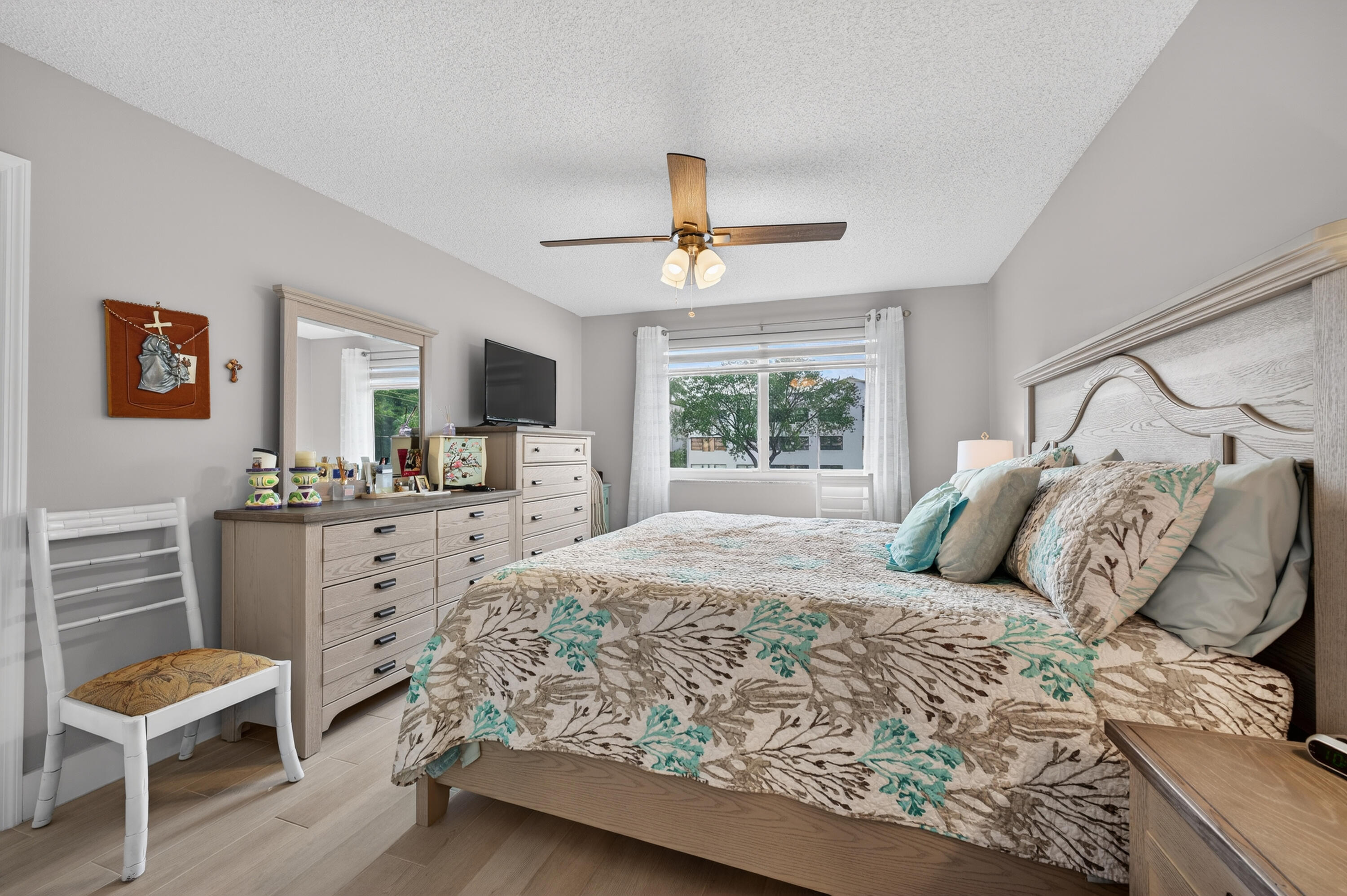 7142 South Devon Drive, Unit 210 Tamarac, FL 33321 - Photo 23 of 36 a bedroom with a large bed and a chair