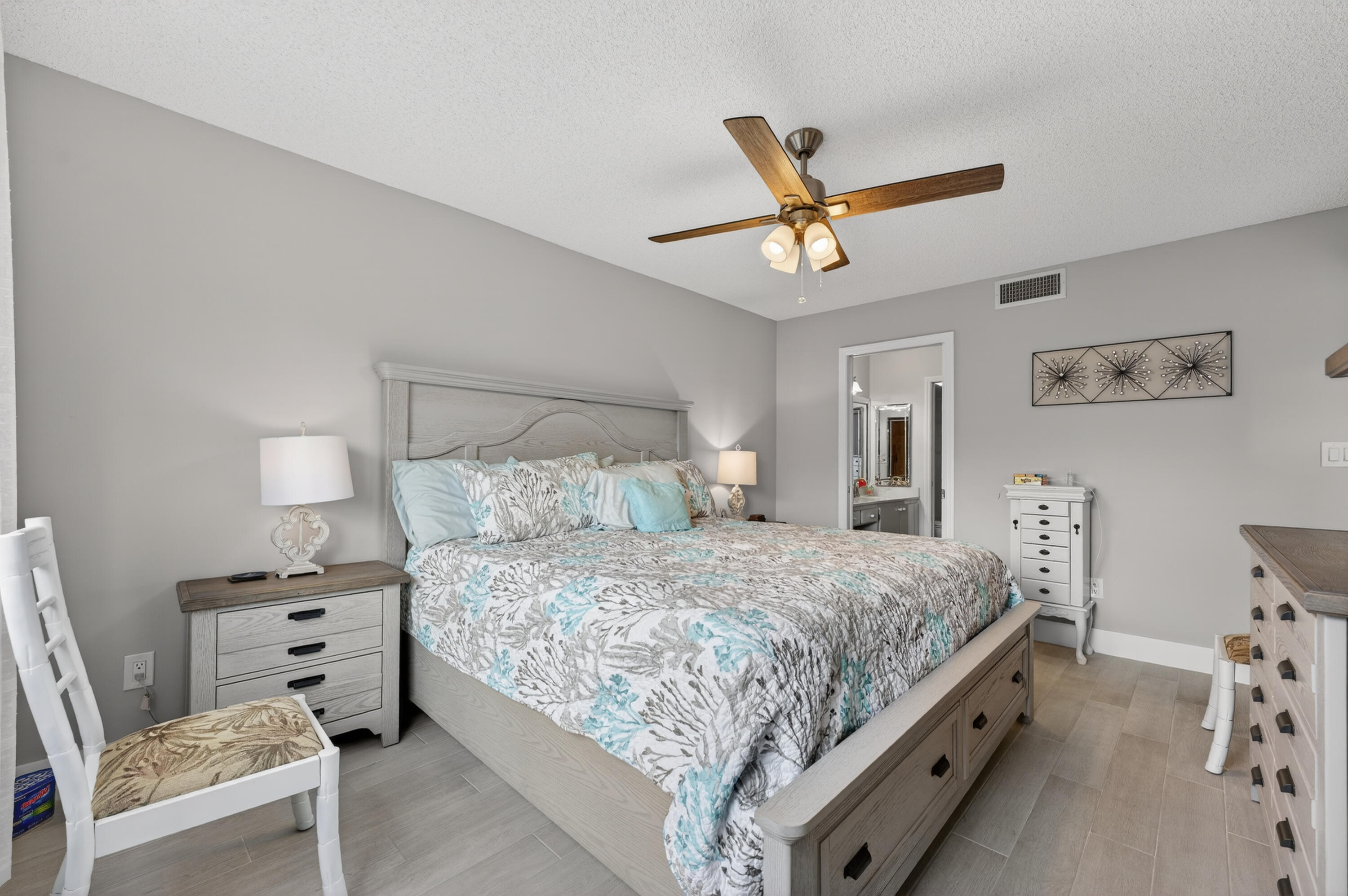 7142 South Devon Drive, Unit 210 Tamarac, FL 33321 - Photo 24 of 36 a bedroom with a bed and a chandelier