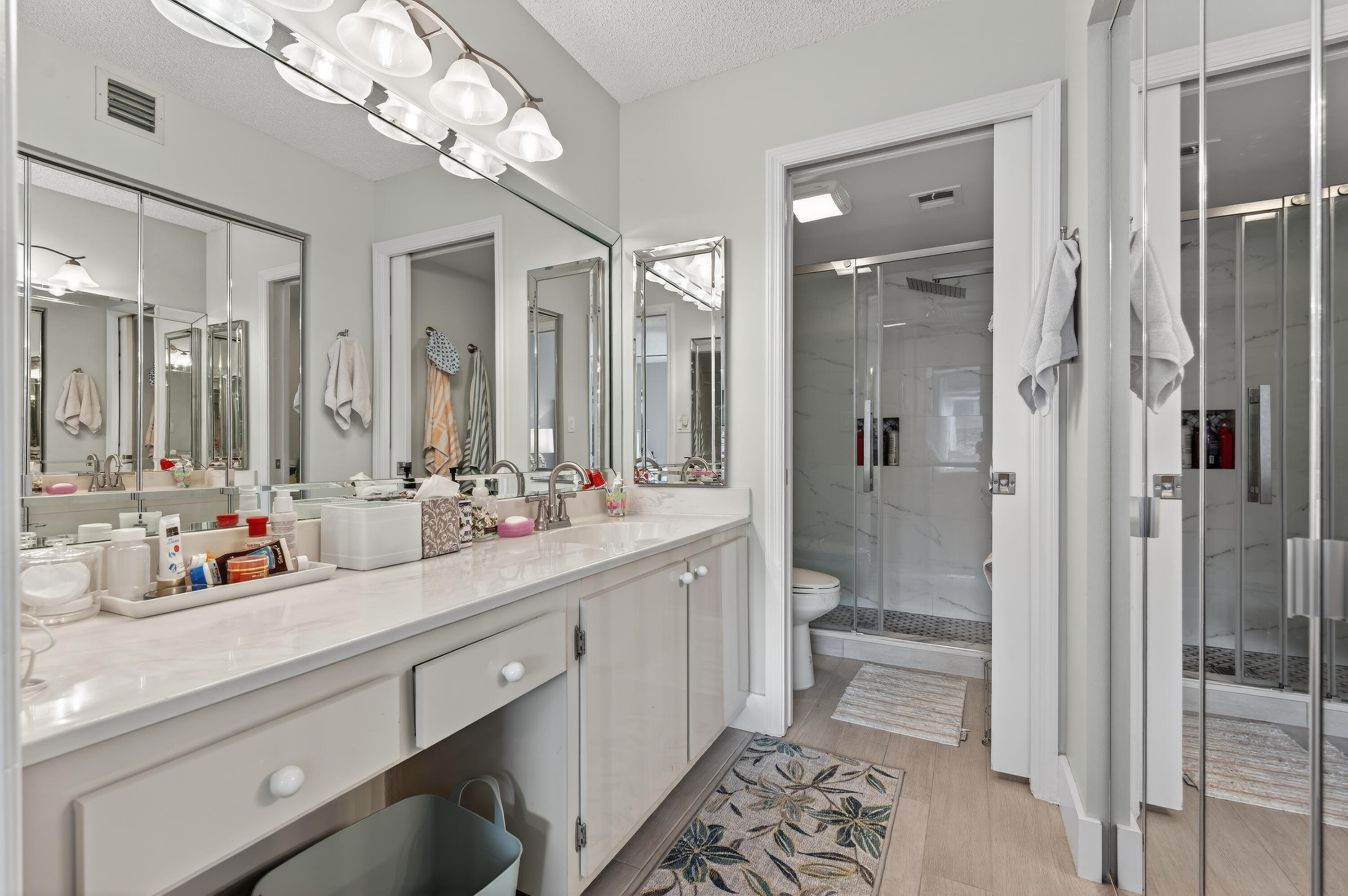 7142 South Devon Drive, Unit 210 Tamarac, FL 33321 - Photo 25 of 36 a bathroom with a double vanity sink mirror and shower