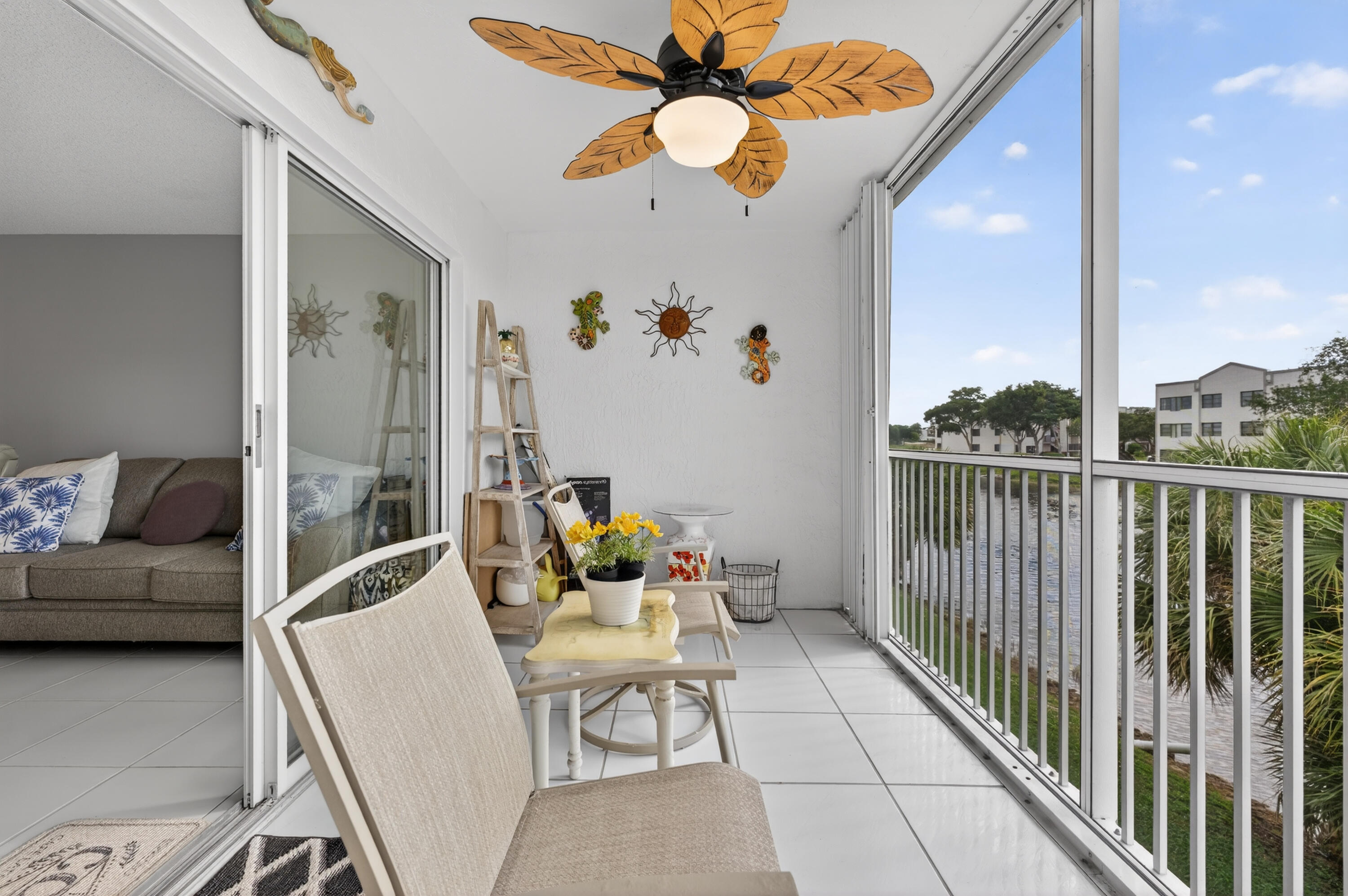 7142 South Devon Drive, Unit 210 Tamarac, FL 33321 - Photo 33 of 36 a living room with furniture and a chandelier