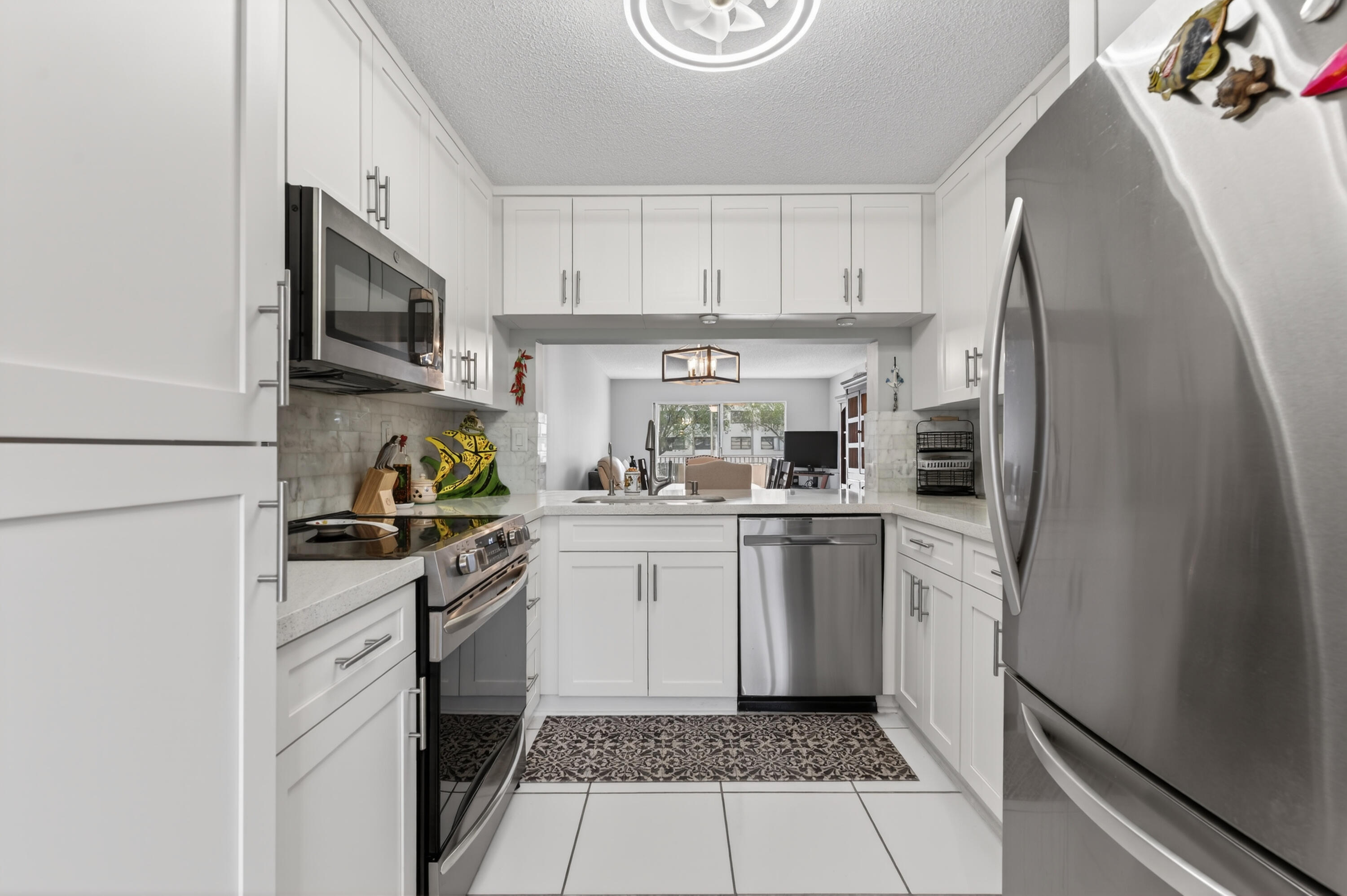 7142 South Devon Drive, Unit 210 Tamarac, FL 33321 - Photo 7 of 36 a kitchen with a white stove top oven and refrigerator