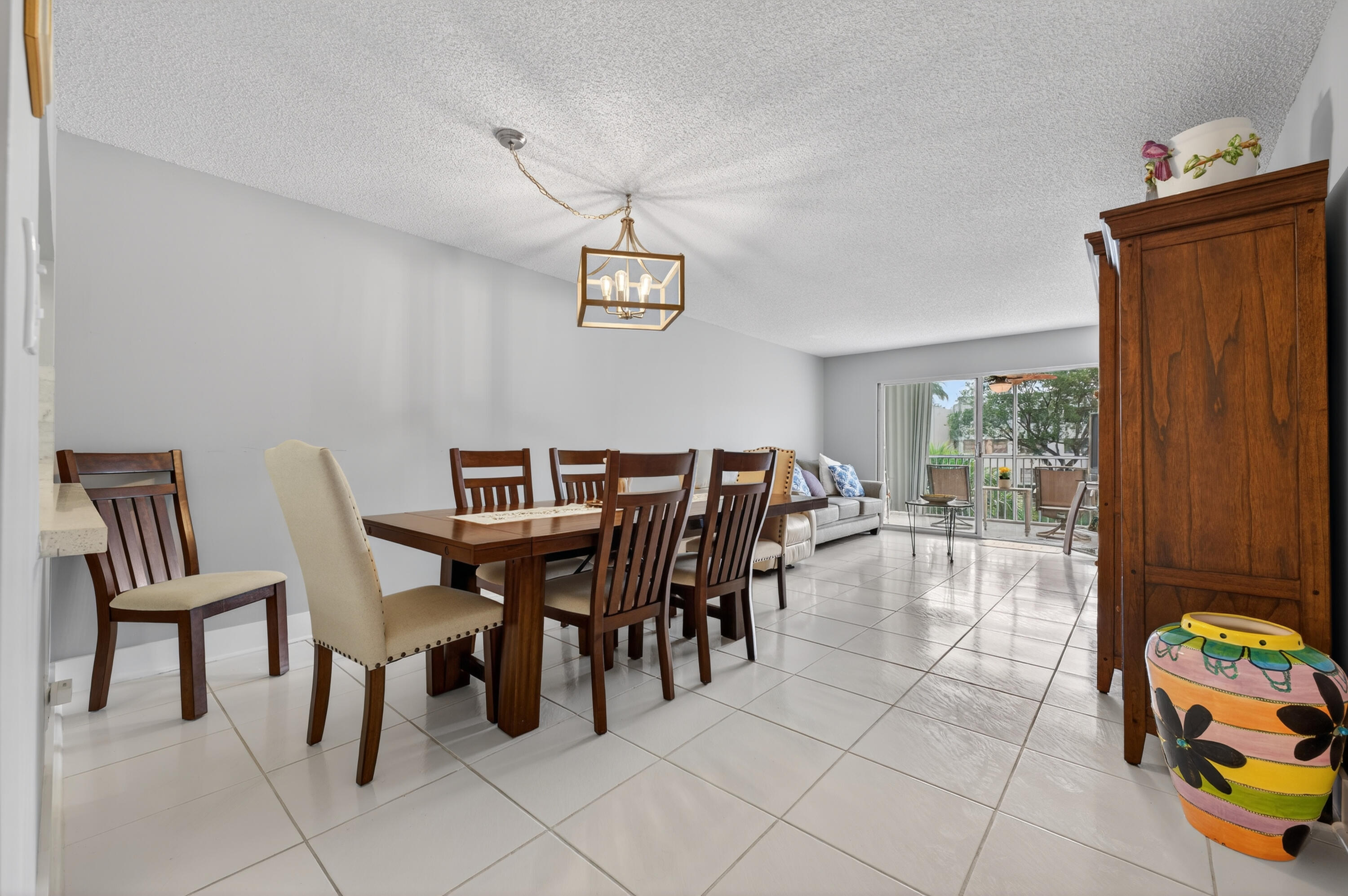 7142 South Devon Drive, Unit 210 Tamarac, FL 33321 - Photo 9 of 36 a view of a dining room with furniture and chandelier