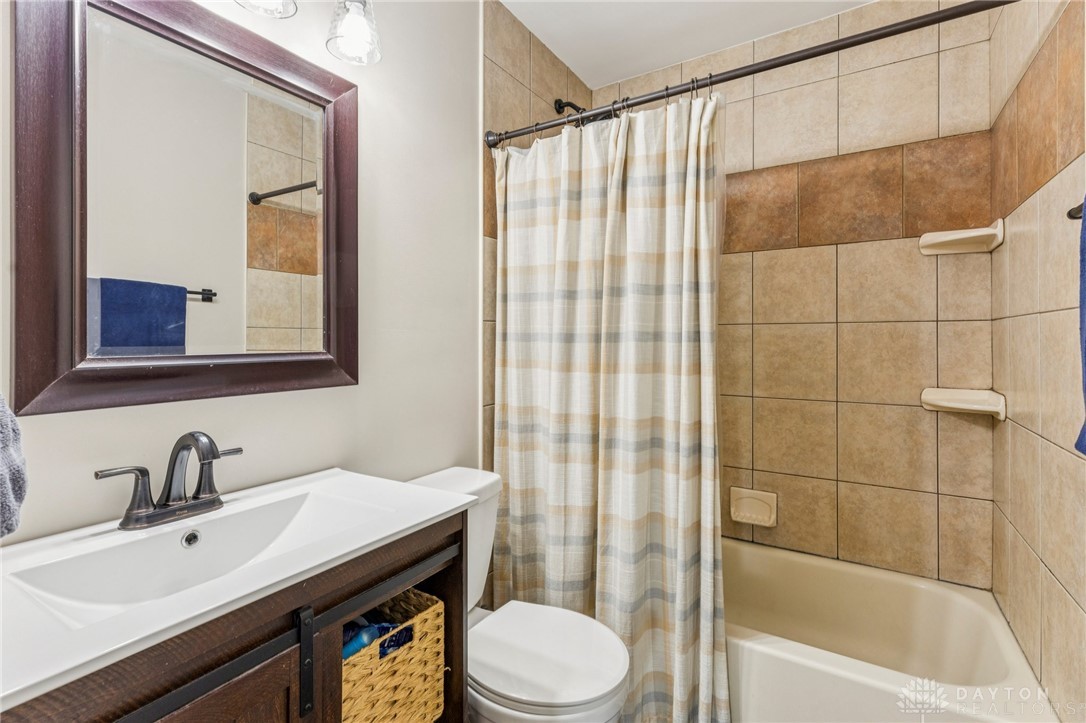 4934 Castleton Drive Fairfield, OH 45014 - Photo 23 of 36 A well-appointed bathroom featuring a clean and modern design with tiled walls and a functional vanity.
