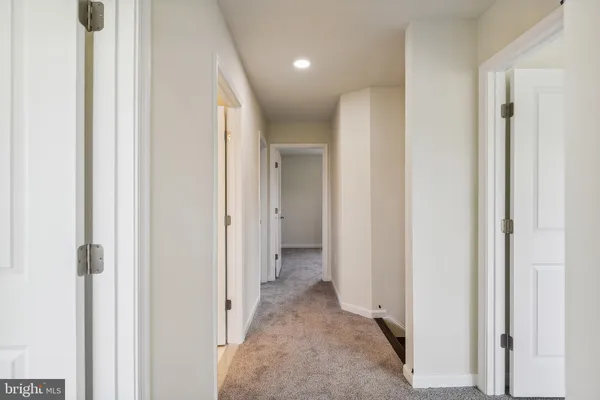 a view of a hallway with closet and wooden floor