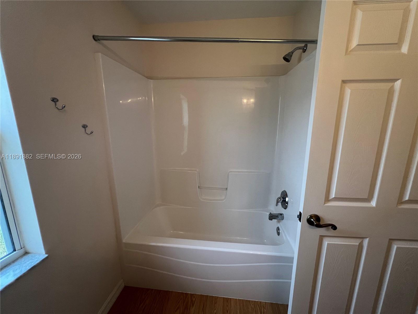 1679 Southwest 156th Lane Ocala, FL 34473 - Photo 11 of 16 a bathroom with a bathtub and a shower